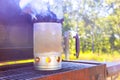 There is a BBQ chimney starter in use right now to get charcoal ready for grill to start glowing Royalty Free Stock Photo