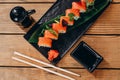 There is a beautiful decorated plate of sushi on the wooden table Royalty Free Stock Photo