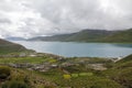 There is a beautiful quiet sapphire blue lake under the green mountain Royalty Free Stock Photo