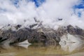 There is a beautiful and quiet snow mountain under the blue sky and white clouds. There is a lake under the snow mountain Royalty Free Stock Photo