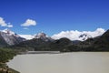 There is a beautiful and quiet snow mountain under the blue sky and white clouds. There is a lake under the snow mountain Royalty Free Stock Photo