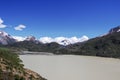 There is a beautiful and quiet snow mountain under the blue sky and white clouds. There is a lake under the snow mountain Royalty Free Stock Photo