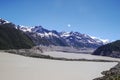 There is a beautiful and quiet snow mountain under the blue sky and white clouds. There is a lake under the snow mountain Royalty Free Stock Photo