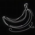 There is a black surface with a single banana drawn on it. The banana is curved and elongated.