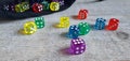 A bag with multicoloured dice spread around Royalty Free Stock Photo