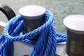 There is a blue rope on the mooring bollard Royalty Free Stock Photo