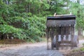 There is a Bobcat tractor moving and unloading gravel on an old road reconstruction project Royalty Free Stock Photo