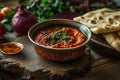 There is a bowl of beet hummus and flatbread on the table