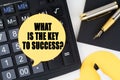 There is a calculator, a pen, a marker and a sticker with the inscription - WHAT IS THE KEY TO SUCCESS Royalty Free Stock Photo