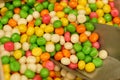 There are candies on the counter - peanuts in multi-colored glaze and a scoop Royalty Free Stock Photo