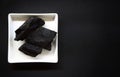 Carbon and bamboo charcoal soap on wood background