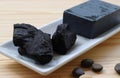 Carbon and bamboo charcoal soap on wood background