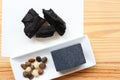 Carbon and bamboo charcoal soap on wood background