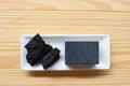 Carbon and bamboo charcoal soap on wood background