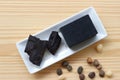 Carbon and bamboo charcoal soap on wood background