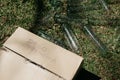 There is a cardboard box positioned on top of a large pile of empty test tubes