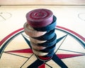 There are carrom coin on the carrom board