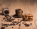 There is a coffee cup with a saucer made of coconut palm wood. From glass jar chaotically scattered roasted coffee beans Royalty Free Stock Photo