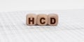 There are cubes on the reporting documents with the inscription - HCD Royalty Free Stock Photo