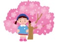 A girl kindergartener in front of a cherry tree in full bloom Royalty Free Stock Photo