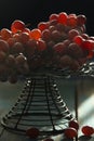 There are fresh grapes on the blue wooden table on the iron flower rack