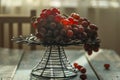 There are fresh grapes on the blue wooden table on the iron flower rack