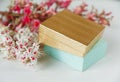 There Gold and Blue Boxes with White and Pink Branches of Chestnut Tree are on White Table,Selective Focus,