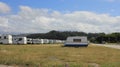 campers and motorhomes fill the parking lot in Foz, Spain