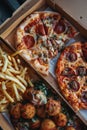 There is half-eaten pizza, burger, and fries on a table. Royalty Free Stock Photo