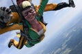 Skydiving. Tandem passenger has a big smile.