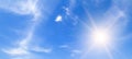 There are light clouds and a bright sun in the blue sky. Wide photo Royalty Free Stock Photo