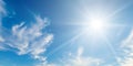 There are light white clouds and bright sun in the blue sky. Wide photo Royalty Free Stock Photo