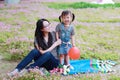 Cute adorable little baby girl smile laugh and play balloon have fun with mother mom with daughter enjoy free time in summer park Royalty Free Stock Photo