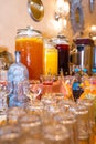 there are a lot of glasses near the containers with drinks Royalty Free Stock Photo