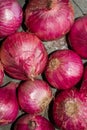 There are a lot of onions lying on the slab of a kitchen with selected focus