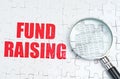 There is a magnifying glass on the puzzles, next to it is written - FUND RAISING