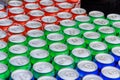 There are many aluminum cans of sparkling drinks such as Sprite, Coca-Cola, Pepsi lying in a row.