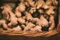 There are many ginger roots in a wicker basket. Harvest vegetables in the grocery store