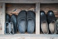 There are many old pairs of galoshes in the form of jewelry on a shelf