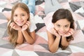 There are many reasons to be happy. Happy kids with cute smiles. Small children relax on bed. Enjoying happy childhood