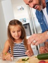 There are many ways to nurture your kids. an adorable little girl cooking with her father at home.