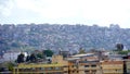 There are modern skyscrapers and constructions of them at the background of the slum neighborhood