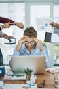 When there are more tasks than hours in a day. a young businessman looking stressed out in a demanding office