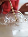 Making soap bubbles on a table Royalty Free Stock Photo