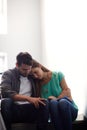 There when she needs a shoulder to cry on. a man comforting a distressed woman in a stairwell.