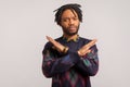 There is no way. Concerned disappointed african man with dreadlocks showing x sign with crossed hands, meaning stop, finish Royalty Free Stock Photo