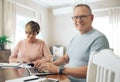 There is nothing better than being financially secure. a mature couple calculating their budget together. Royalty Free Stock Photo