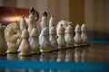 There are old chess pieces. White chess pieces made of porcelain close-up