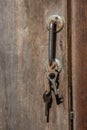 There are old keys hanging on the door handle Royalty Free Stock Photo