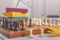 There is old wooden chessboard on table. Game began, players made their moves. Royalty Free Stock Photo